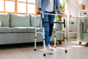 Senior woman using mobility walker at home.