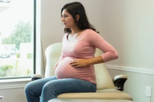 Adult expectant mother listens as the doctor answers her questions.
